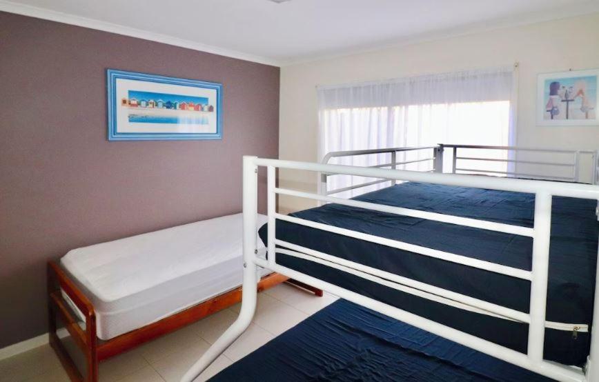 a bedroom with two bunk beds and a window at 5 36 Maurice Avenue in Mallacoota