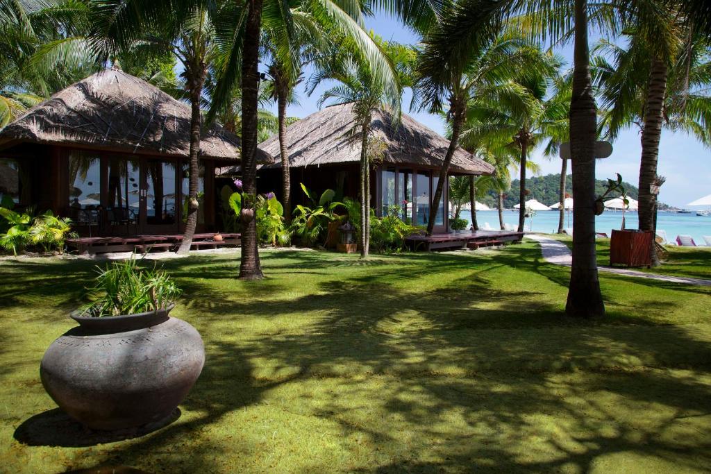 a resort with a large vase sitting in the grass at Mali Resort Pattaya Beach Koh Lipe in Ko Lipe