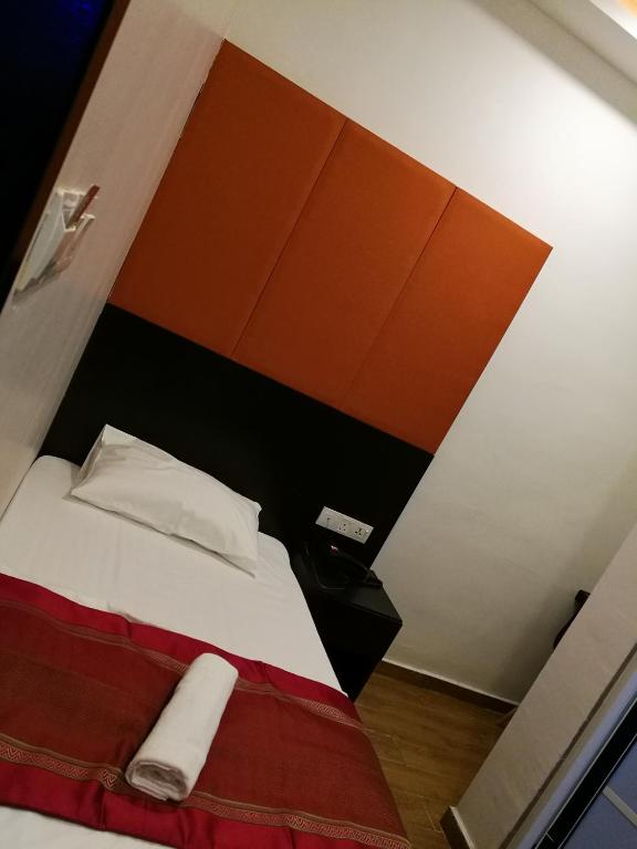 Postel nebo postele na pokoji v ubytování D'Spark Hotel Bayu