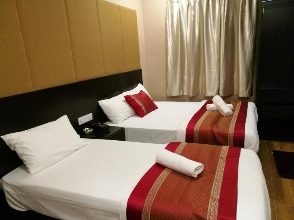 Postel nebo postele na pokoji v ubytování D'Spark Hotel Bayu