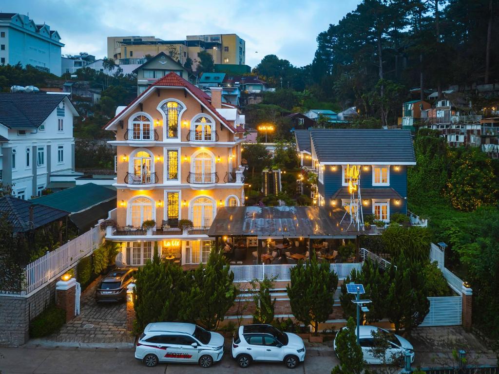 a large house with cars parked in front of it at La Cle' Đà Lạt in Da Lat