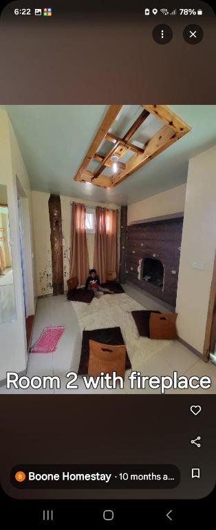 a screenshot of a room with a room with fireplace at Boone Homestay in Sagada