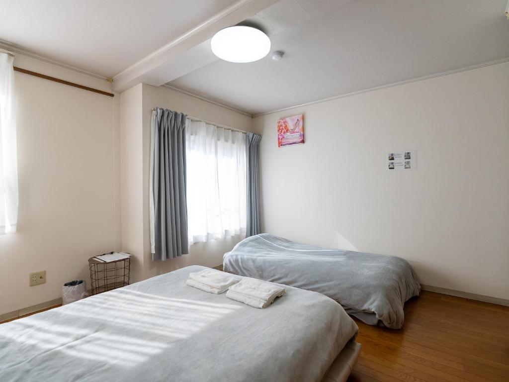 Postel nebo postele na pokoji v ubytování まち宿門
