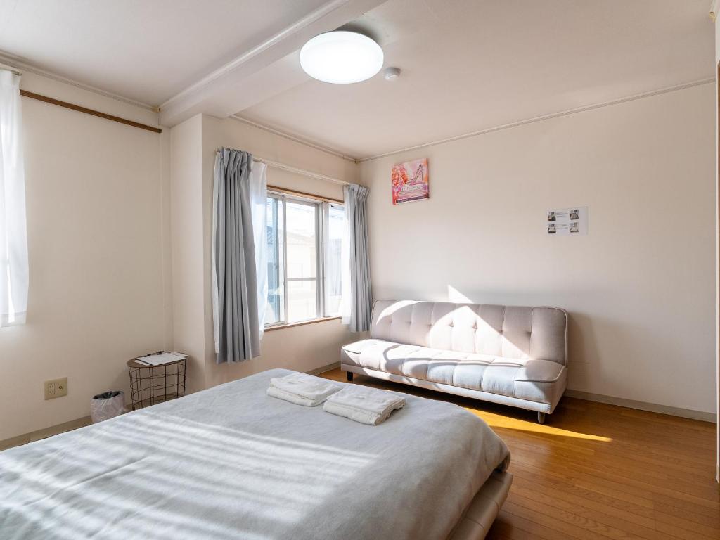 Postel nebo postele na pokoji v ubytování まち宿門