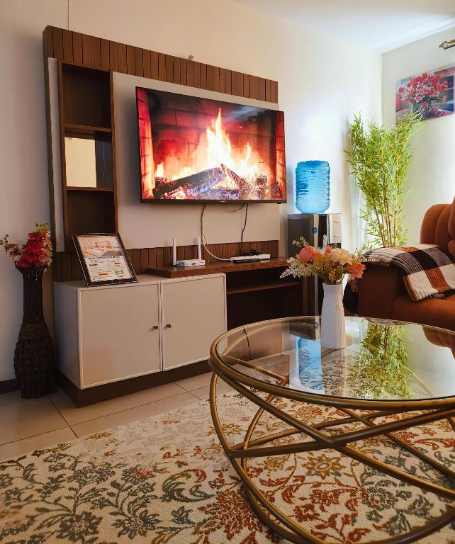 a living room with a tv on a wall at Havan Furnished Apartments-Milimani N8 in Nakuru