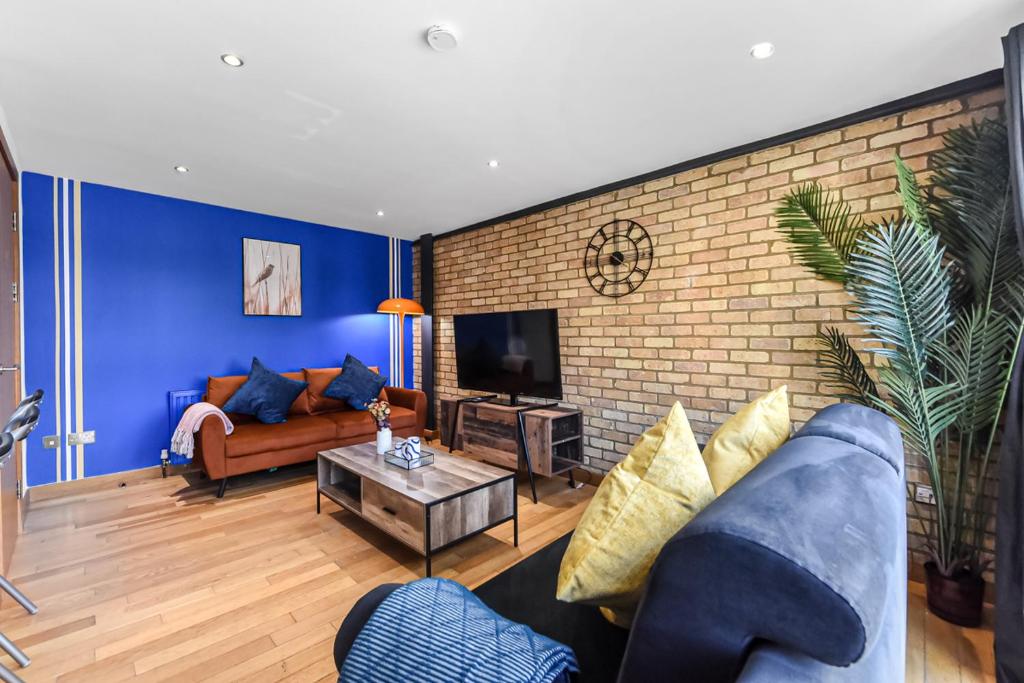 a living room with a couch and a tv at Zone 1, Family Friendly, 2 Beds, Central London in London
