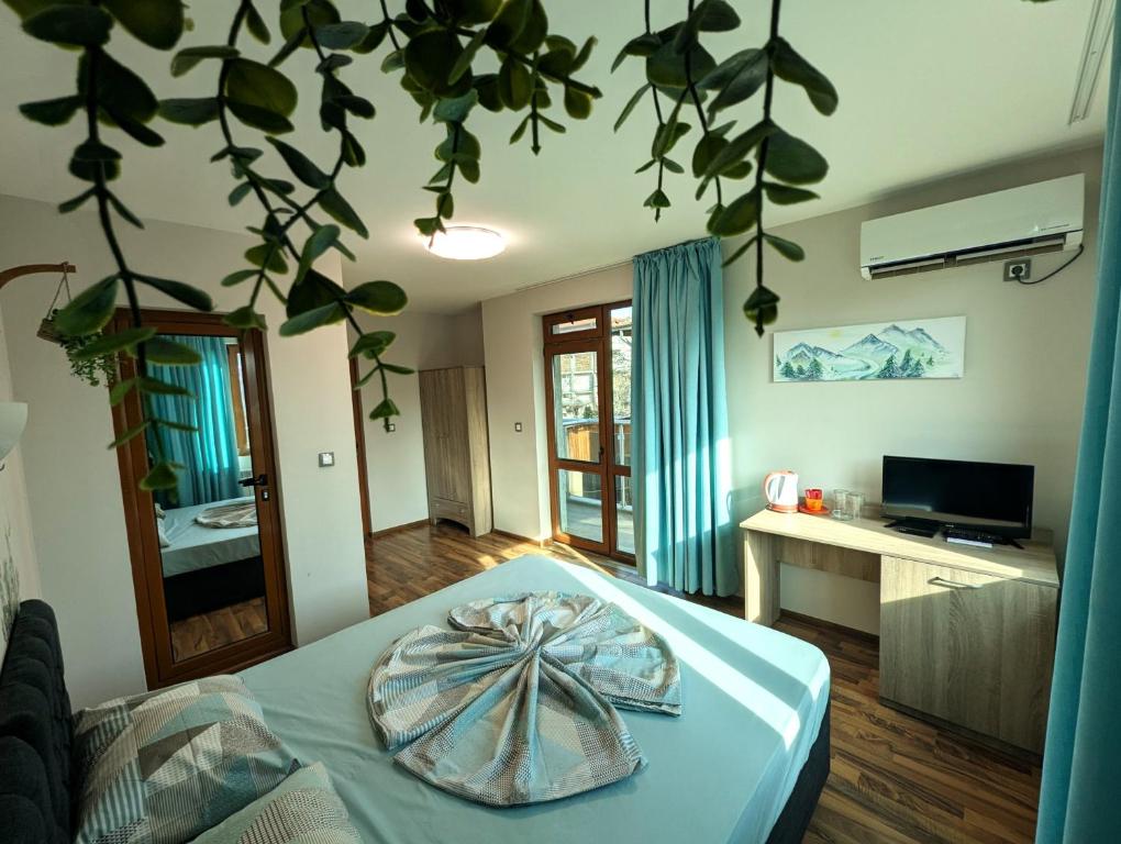 a bedroom with a bed with a bowl on it at Guest house Sineva in Primorsko