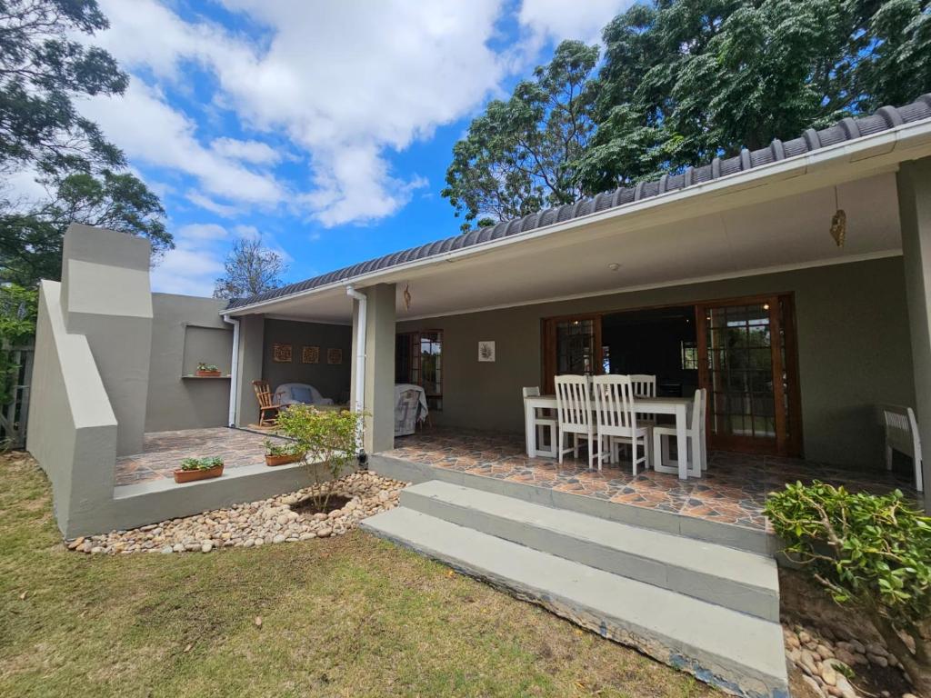 a home with a patio and a house at GUINEA FOWL in Plettenberg Bay