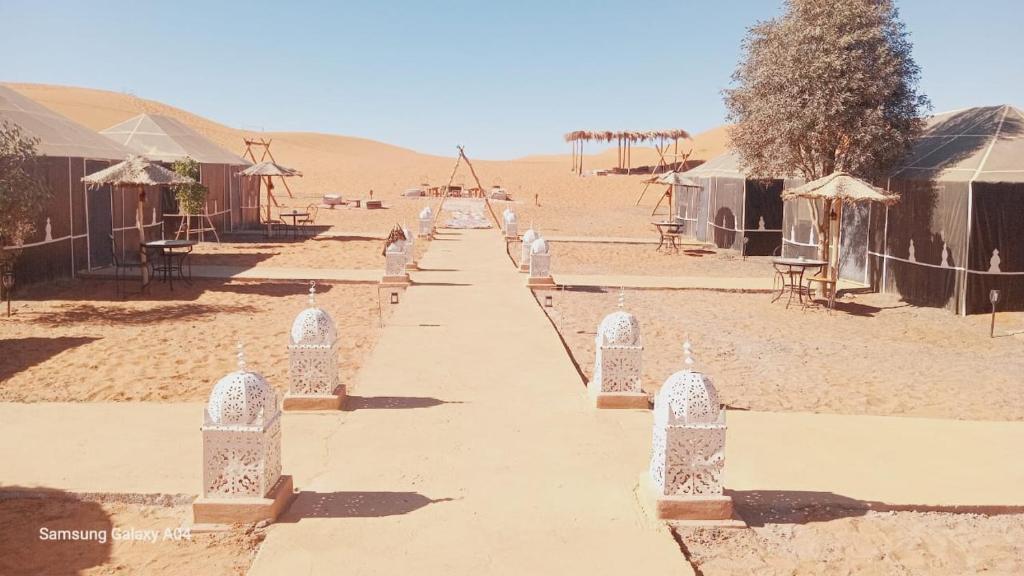 a road in the middle of the desert at Authentic Sahara Desert Camps in Merzouga