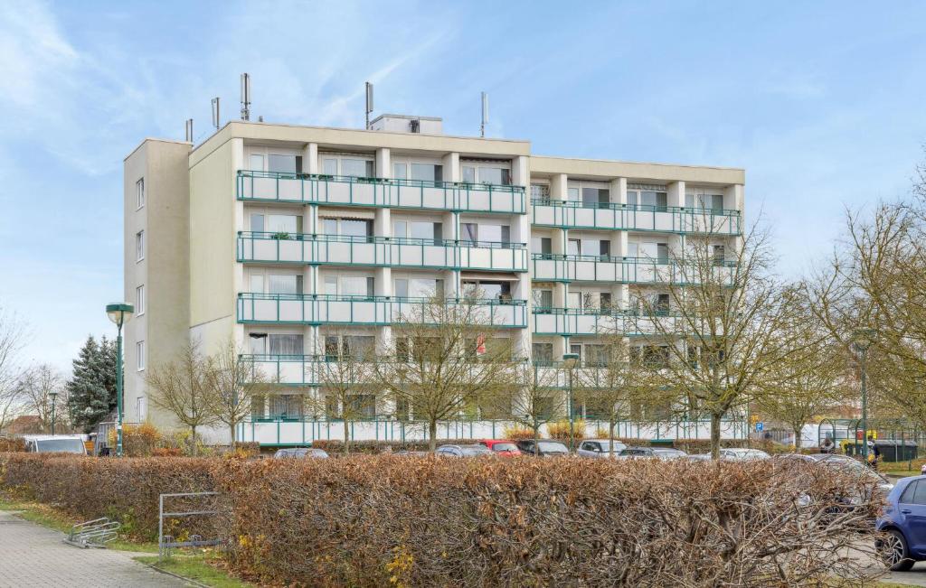 a tall building with cars parked in front of it at Stunning Apartment In Anklam in Anklam