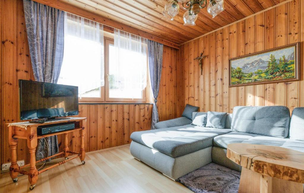 a living room with a couch and a flat screen tv at Gemuetliches Ferienhaus in Schöder