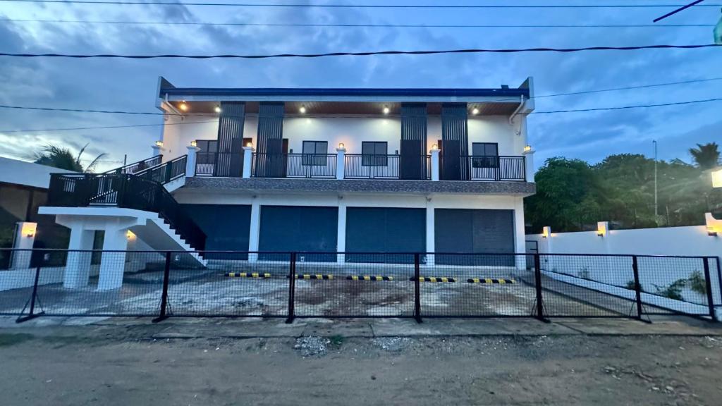 a large white house with a porch and stairs at CasaJuana Room Rental in Carles