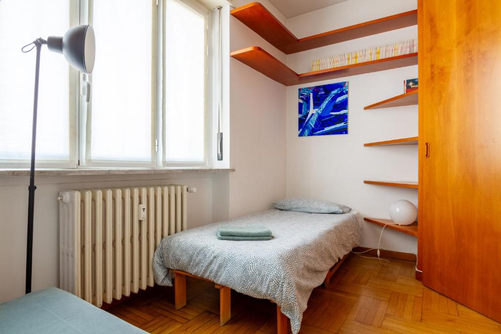 Posteľ alebo postele v izbe v ubytovaní attico con terrazzo navigli bocconi - NavigliApartments