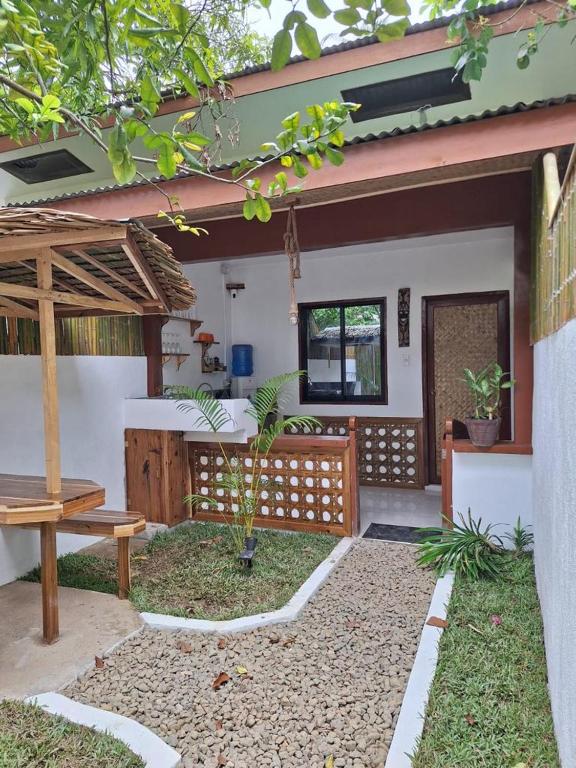 a patio of a house with a table and a bench at Secret spot 3 in El Nido
