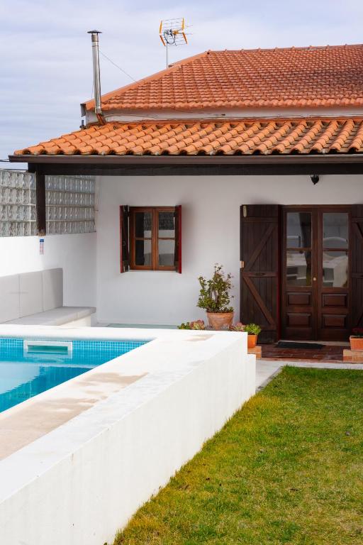 a white house with a swimming pool in front of it at Casa de Maiorca in Maiorca
