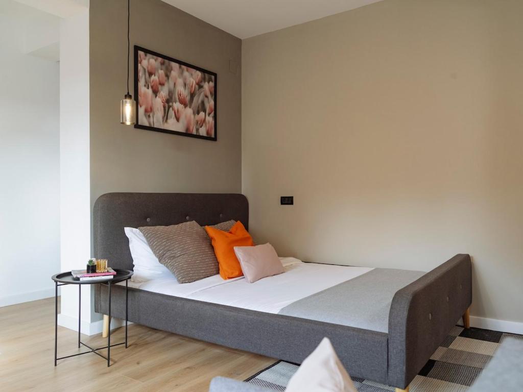 a large bed in a room with a bed frame at Aura - Old Town I Free street parking I Self check-in in Bucharest