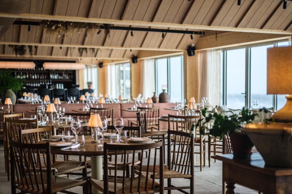 a dining room with tables and chairs and windows at Copenhagen Admiral Hotel in Copenhagen