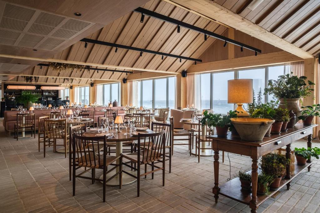 a dining room with tables and chairs and windows at Copenhagen Admiral Hotel in Copenhagen