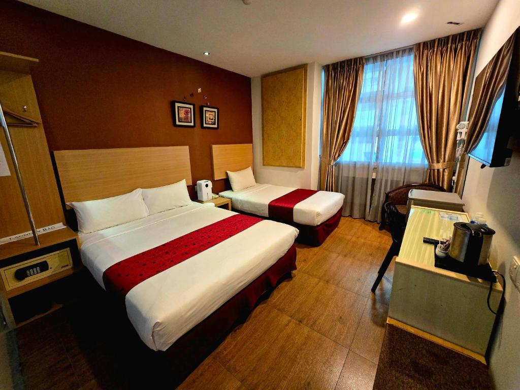 Postel nebo postele na pokoji v ubytování Eight Days Boutique Hotel - Permas Jaya
