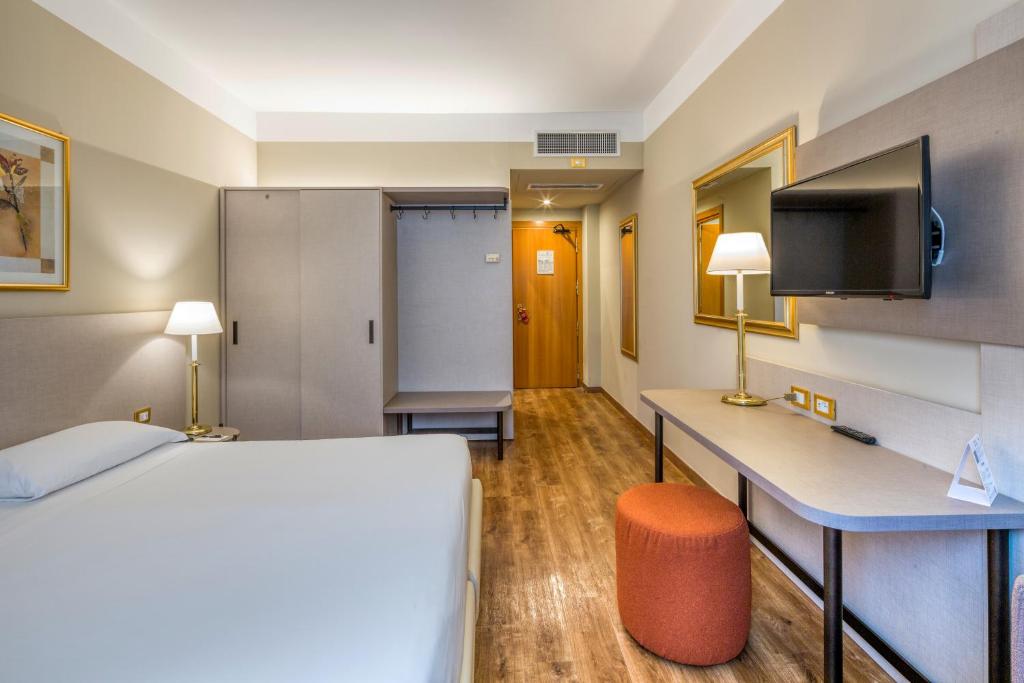 Postel nebo postele na pokoji v ubytování Hotel Nasco