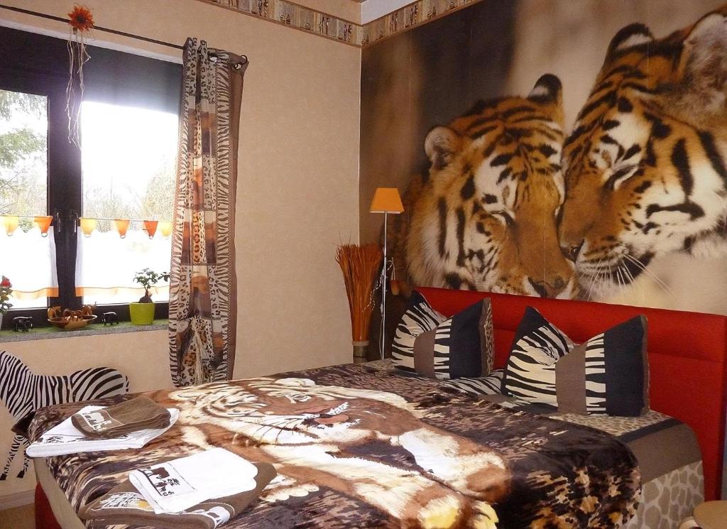 a bedroom with a mural of tigers on the wall at Blick In Die Natur in Ilmenau