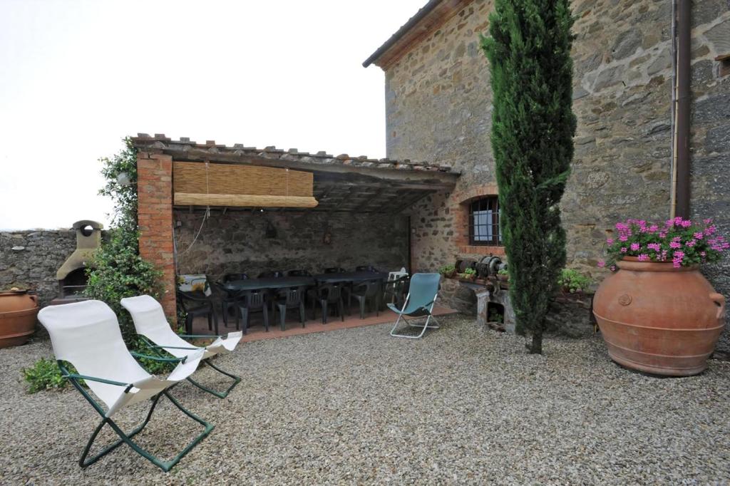 a patio with chairs and a table and a vase at Giovanni in Rapale