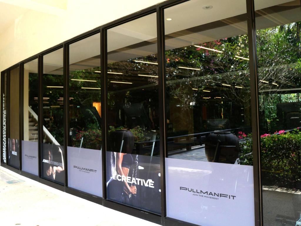 a display window in a building with plants at Pullman Phuket Karon Beach Resort in Karon Beach