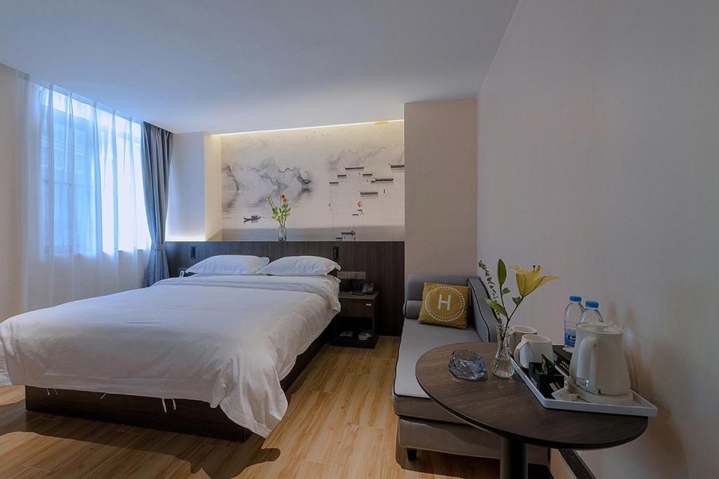 Postel nebo postele na pokoji v ubytování Andy International Hotel Shenzhen University Nanshan Metro Branch