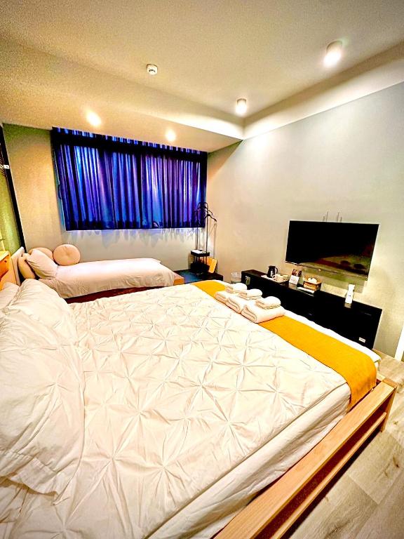 Postel nebo postele na pokoji v ubytování Yi Piao B&B