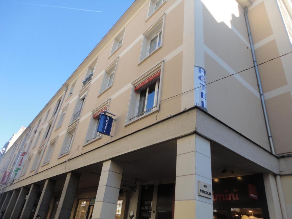 a building on the corner of a street at Hotel Les Arcades in Rouen