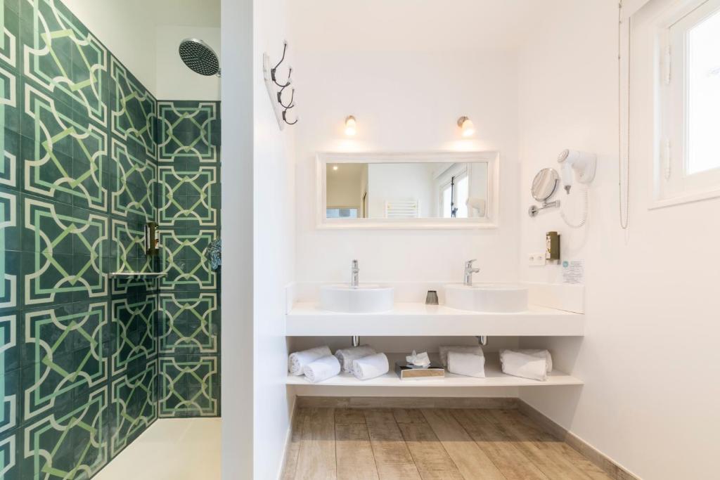 a bathroom with two sinks and a mirror at Les Capucines Saint Tropez in Saint-Tropez