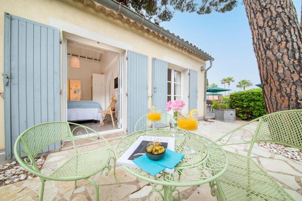 a glass table with a bowl of fruit on it on a patio at Les Capucines Saint Tropez in Saint-Tropez