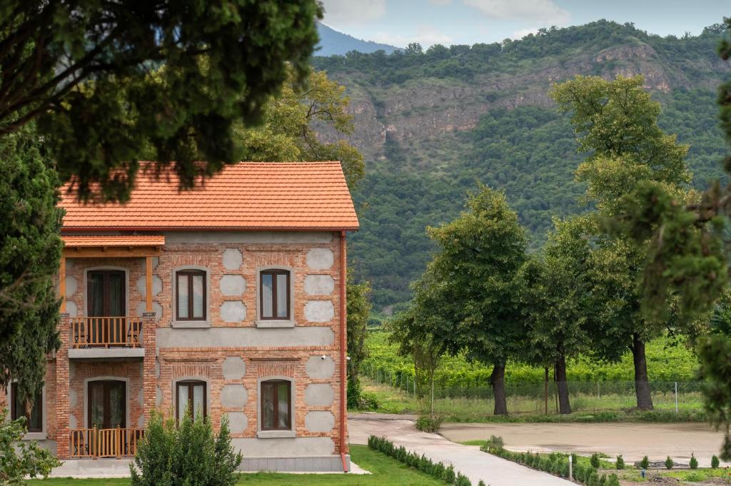 a brick building with a balcony on top of it at Samzeo Kvareli in Kvareli