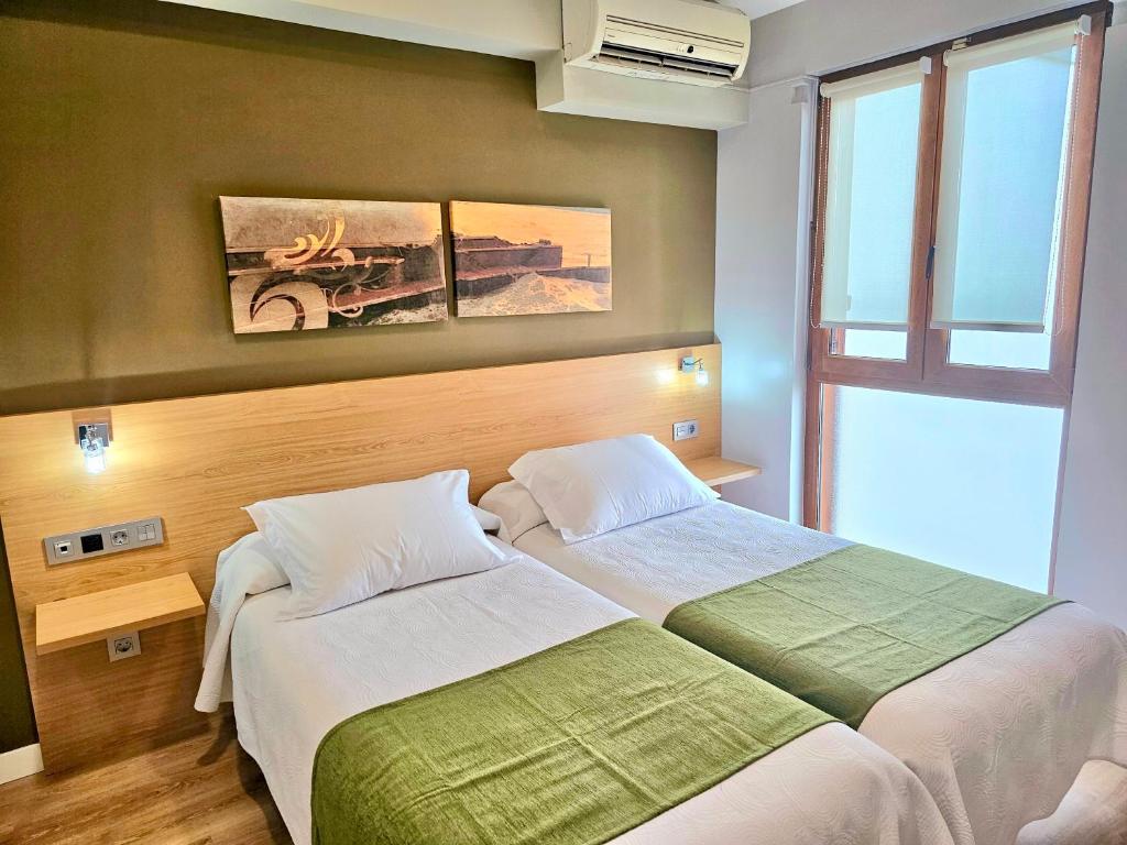 Postel nebo postele na pokoji v ubytování Hotel Olatu