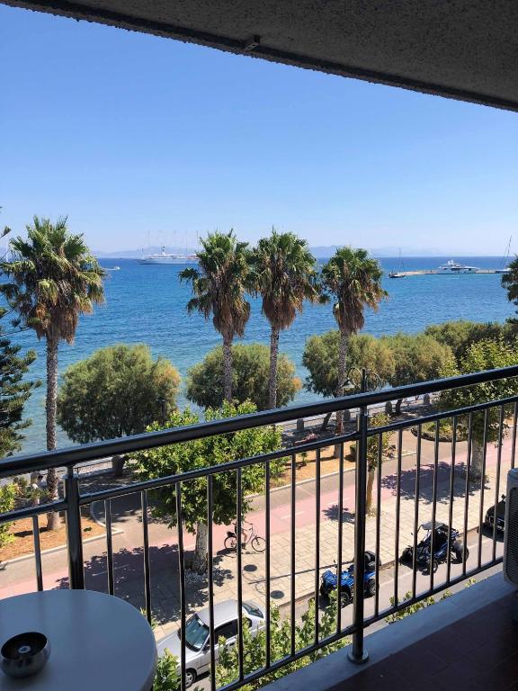 a view from a balcony with palm trees and the ocean at Kos City Sunstone Hotel in Kos