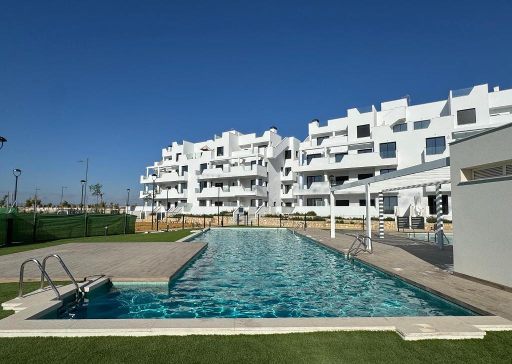 a swimming pool in front of a large apartment building at Santa Rosalía Lake and Life - INVBUILD ESTATES in Torre-Pacheco