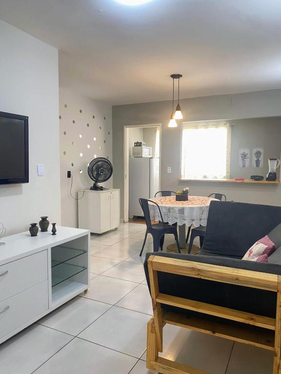 a living room with a table and a dining room at Apartamento Studio 201 in Juazeiro