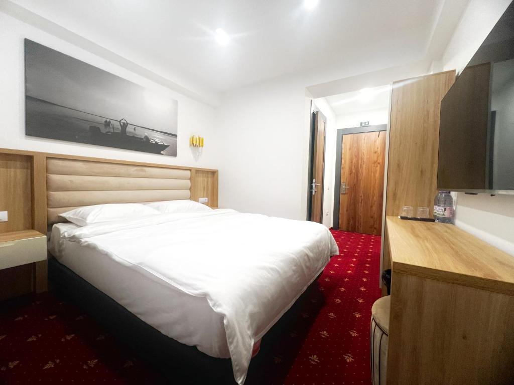 Postel nebo postele na pokoji v ubytování Mimi Hotel