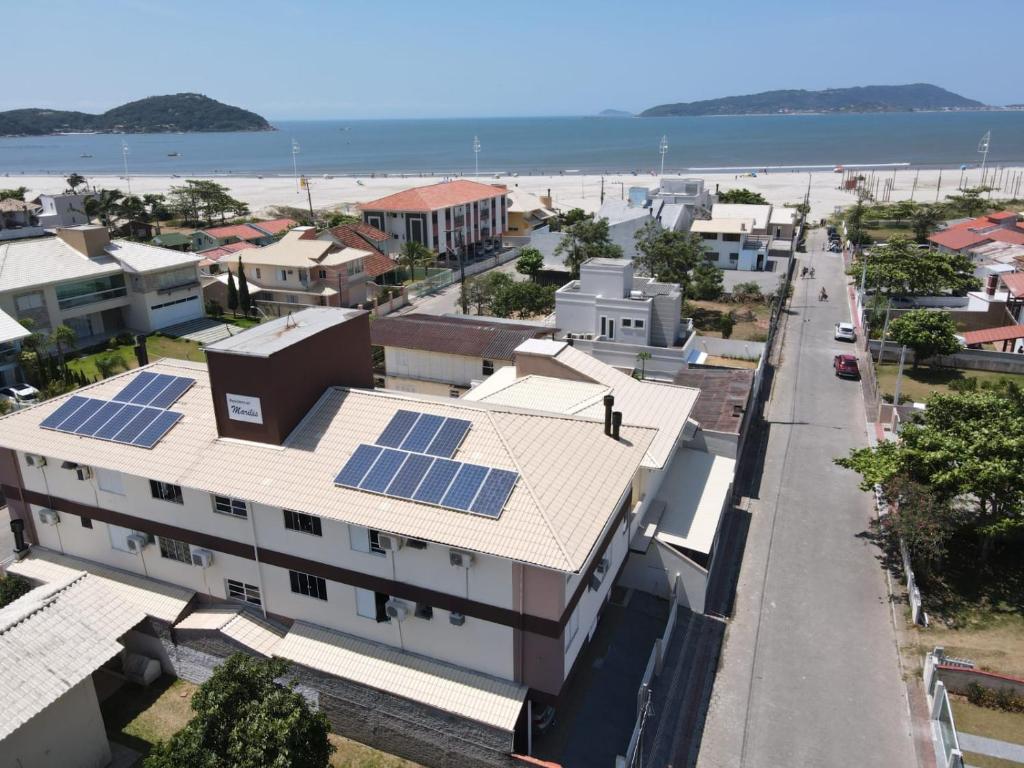 a city with solar panels on the roofs of buildings at Residencial Marilis in Palhoça