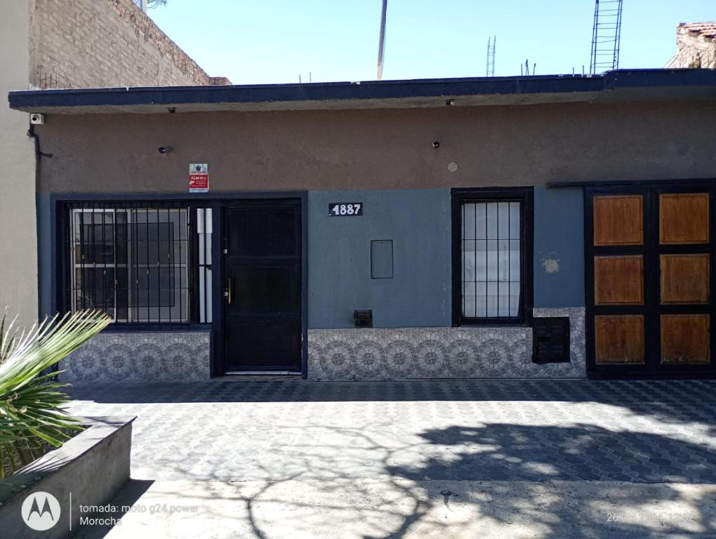 a building with two doors and a sign on it at La Boca in Godoy Cruz