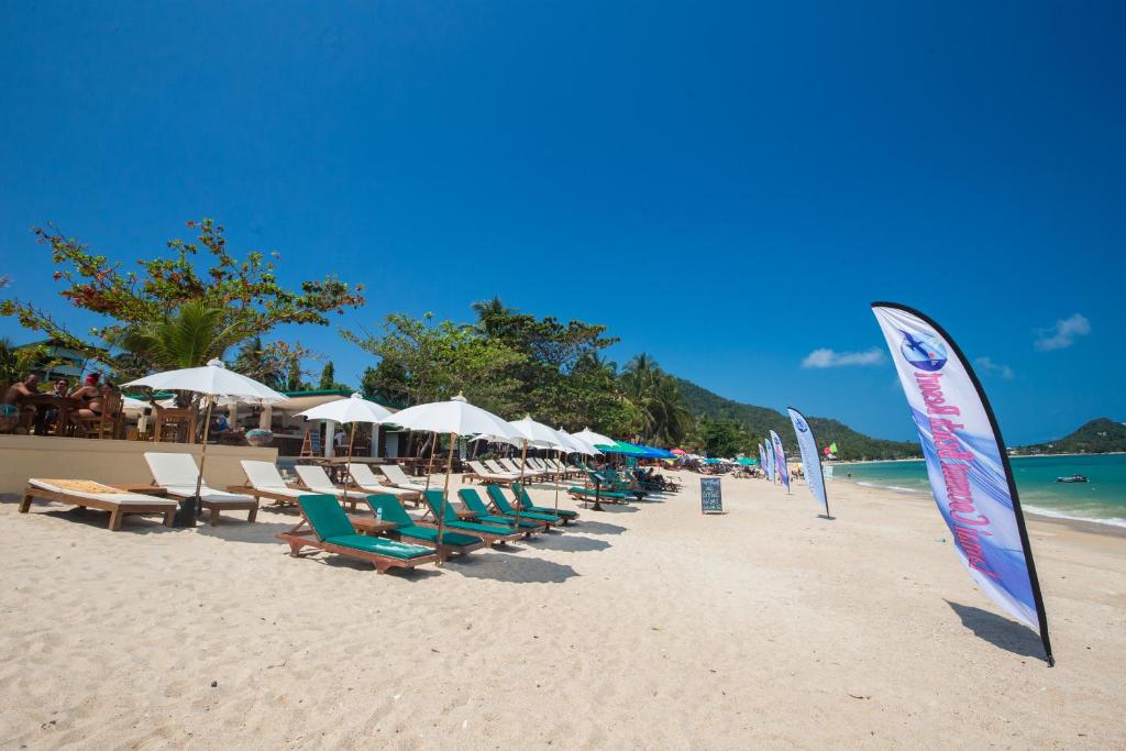 a group of chairs and umbrellas on a beach at Lamai Coconut Beach Resort in Lamai
