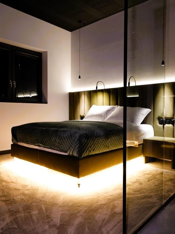 ein Schlafzimmer mit einem großen Bett und Bodenleuchten in der Unterkunft Stolarnia Winehouse in Łaziska Górne