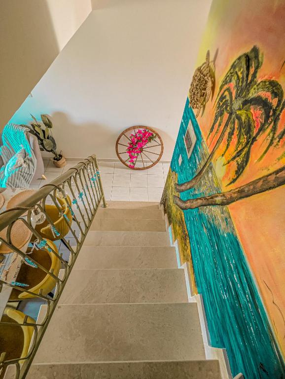 a staircase with a mural on the wall at Arting Sea-A Dog friendly house in Khlorakas