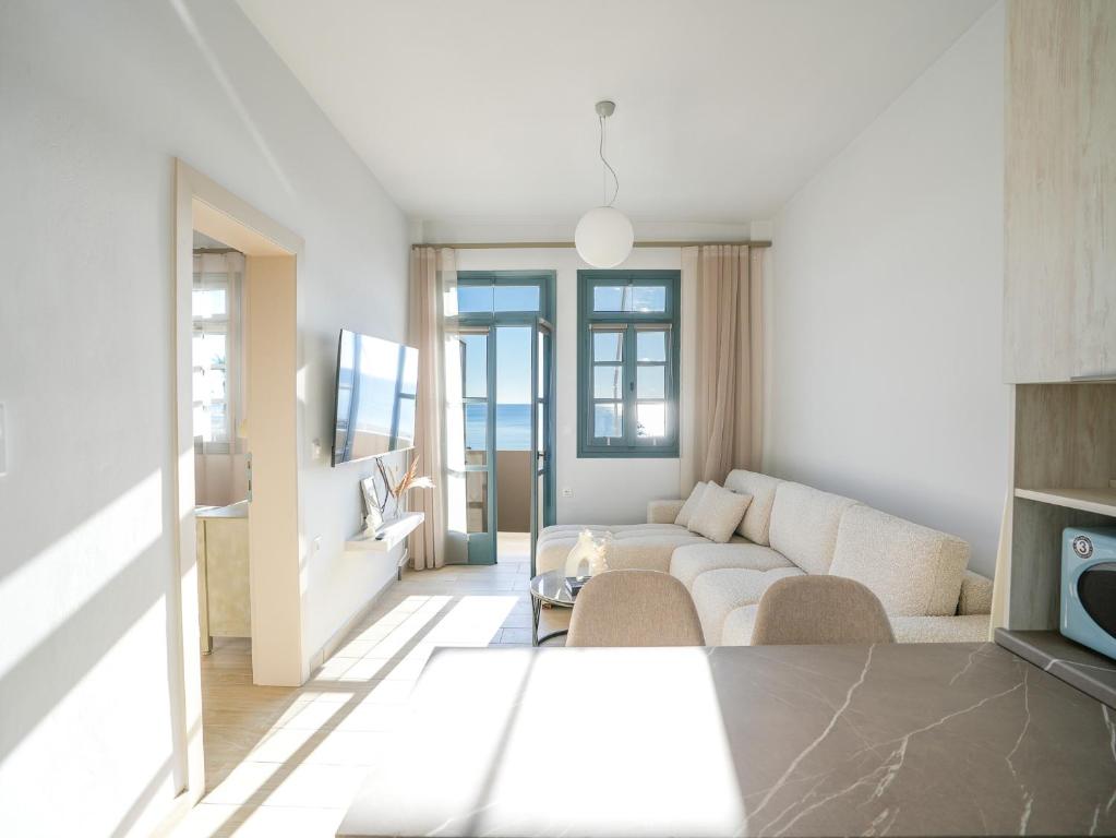 a living room with a couch and a table at Dolce Vista VN Luxury Apartments in Kardamaina