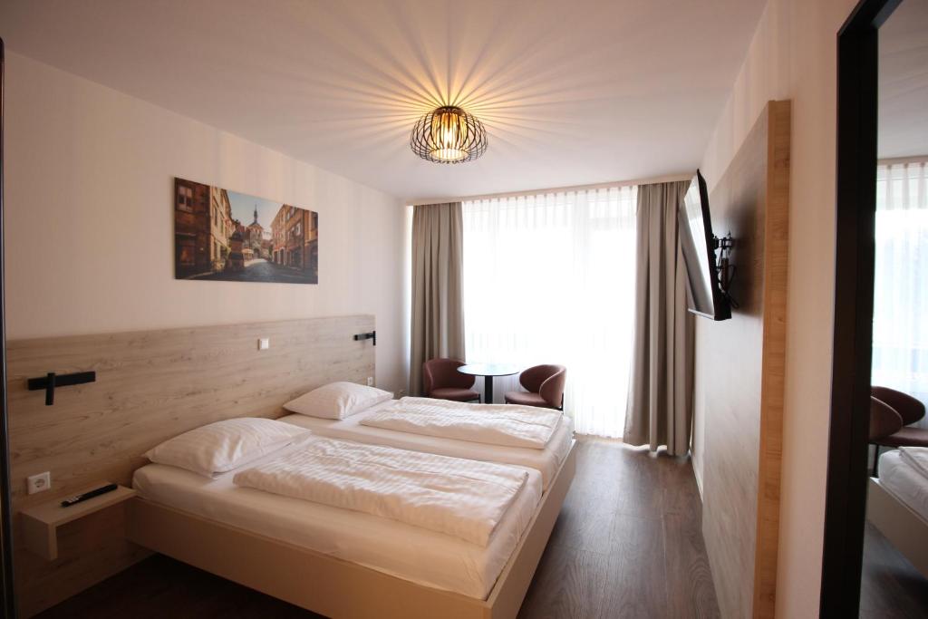 Postel nebo postele na pokoji v ubytování Das HOB - Hotel Original Bamberg