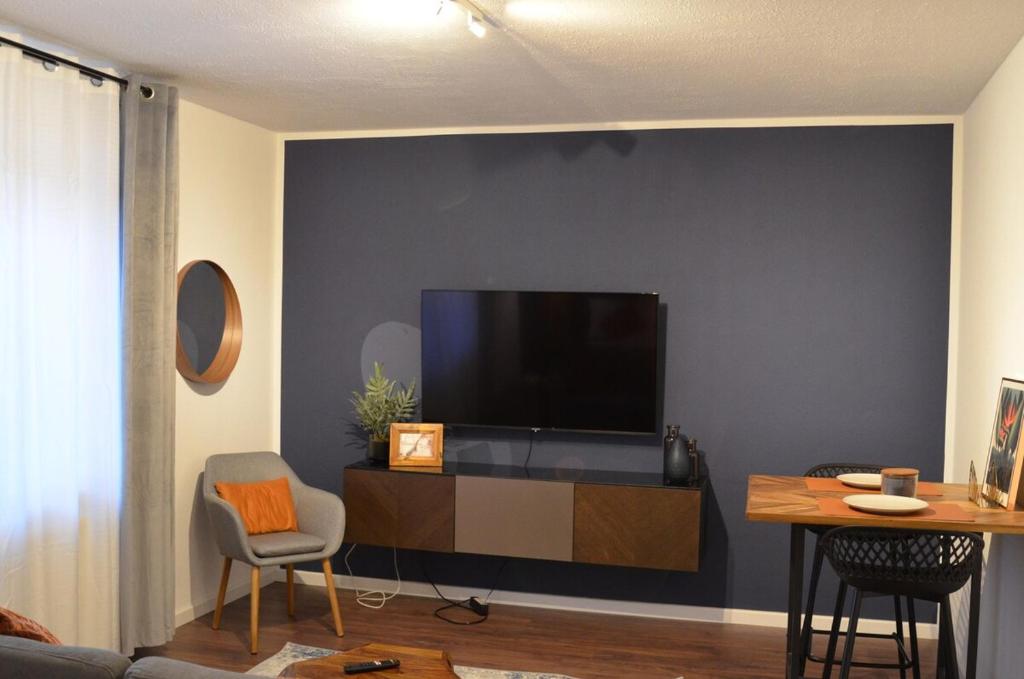 a living room with a flat screen tv on a wall at Apartment 17 in Kassel