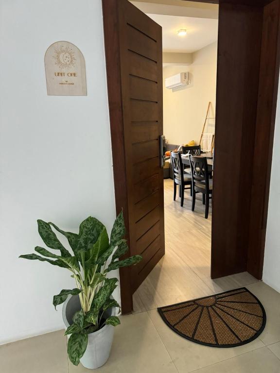 a hallway with a door and a potted plant at Unit One by Hideout Lounge in Kandy