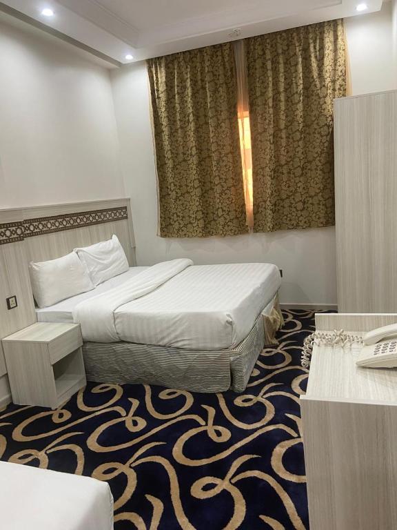 Postel nebo postele na pokoji v ubytování AKABER ELSHESHA awtadhotel2 اكابر الششة اوتاد هوتيل 2