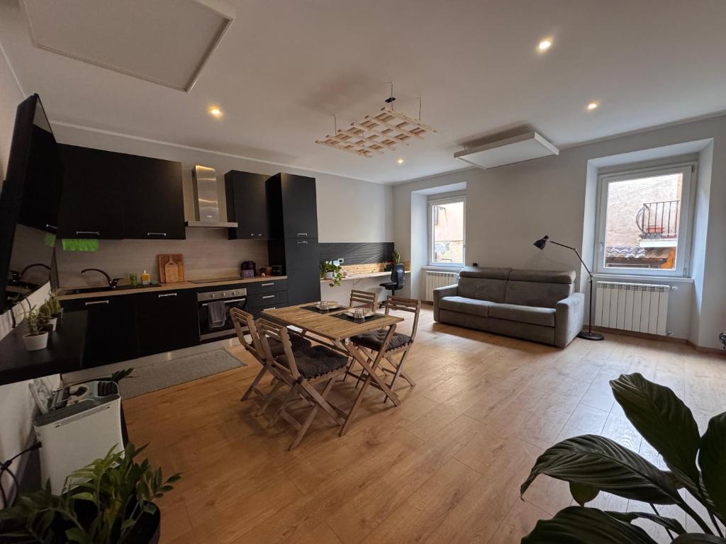 a kitchen and living room with a table and chairs at La Dea Bendata in Rocca Priora
