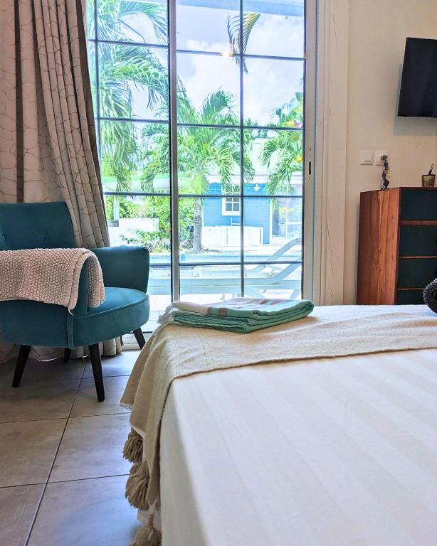 Postel nebo postele na pokoji v ubytování Mon'Désir Lodge - Bungalows